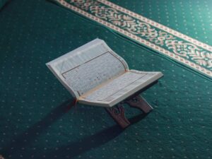 a close up of the Quran on a prayer rug